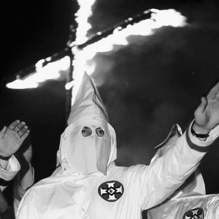 Ku Klux Klan member with torch contrasted against text about Mound Bayou’s refuge for Black families
