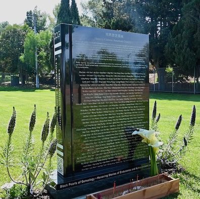 Black granite memorial at the Historic Chinese American Cemetery, donated by Black Pearls of Genealogy, with engraved names of Chinese American pioneers.